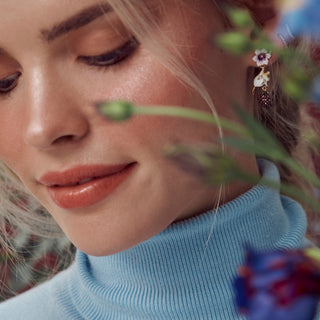 Blackberry & Mouse Earrings on model with tiny purple flower